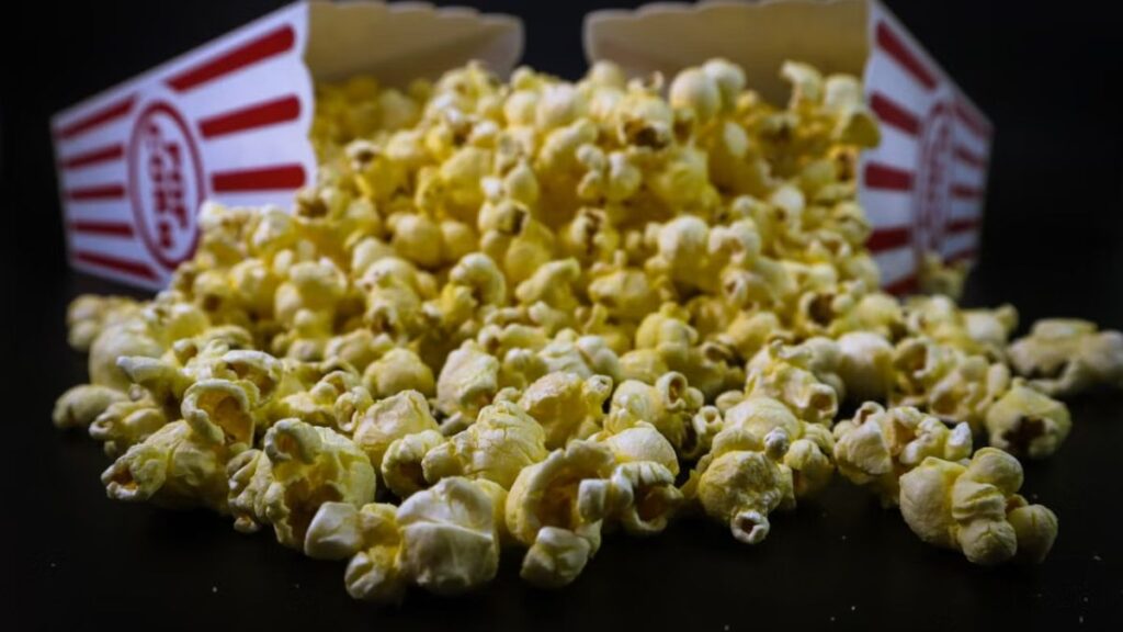 Granos de maíz reventando y convirtiéndose en palomitas dentro de una olla